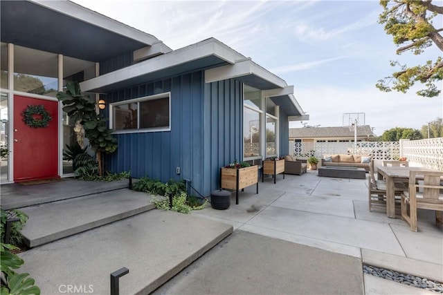 view of side of home with a patio and an outdoor hangout area