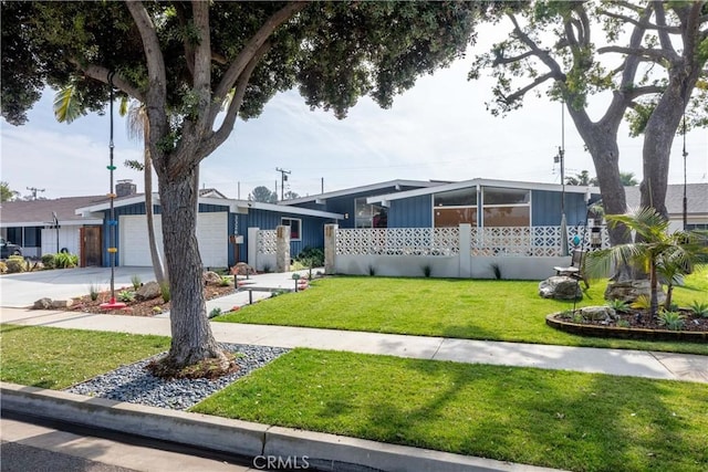 view of front of house with a garage and a front yard