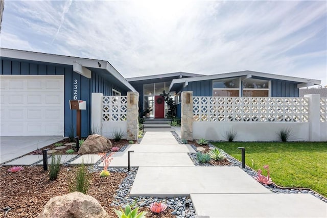 view of front of property featuring a garage and a front lawn