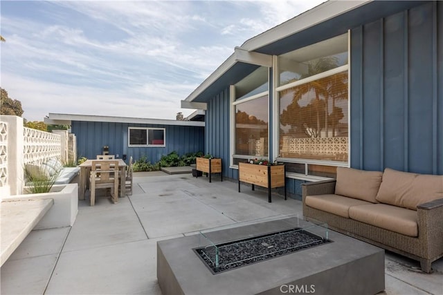 view of patio / terrace featuring an outdoor living space with a fire pit