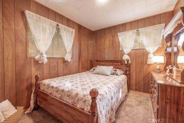 carpeted bedroom with wood walls