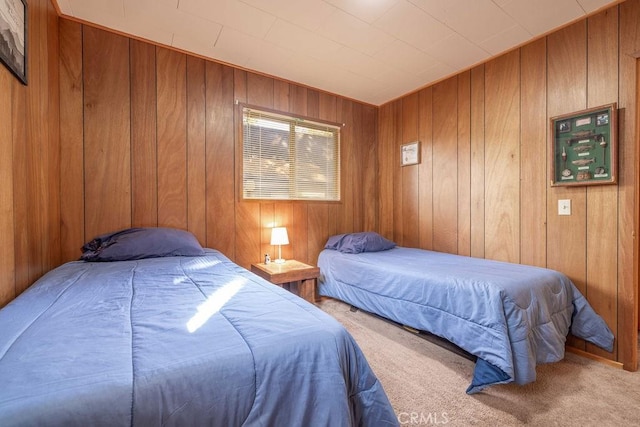 carpeted bedroom featuring wooden walls