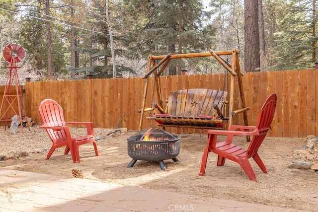 view of playground featuring an outdoor fire pit