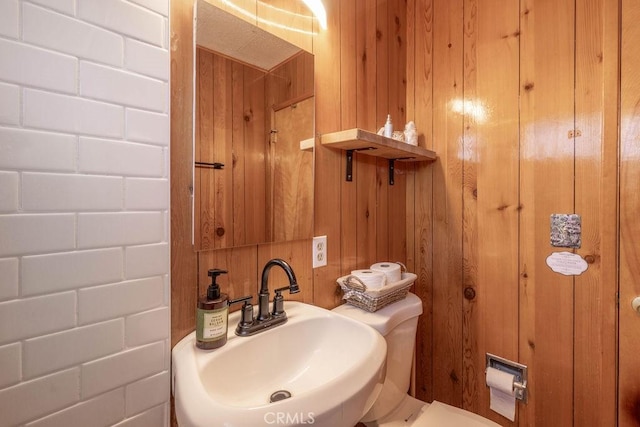 bathroom with sink and wooden walls