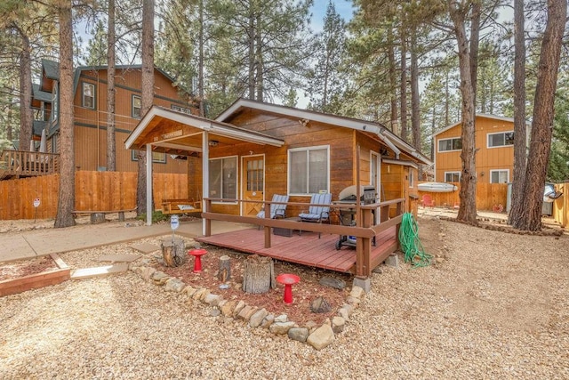 rear view of property with a wooden deck