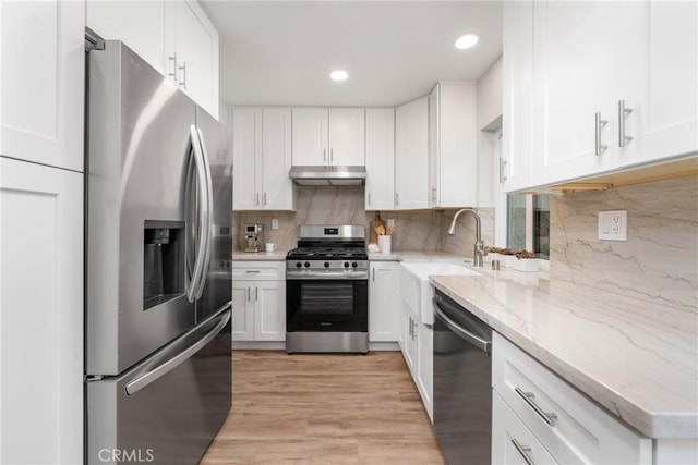 11 Summerwalk Ct Unit 39, Newport Beach, CA 92663 - kitchen with sink, appliances with stainless steel finishes, light stone counters, tasteful backsplash, and white cabinets