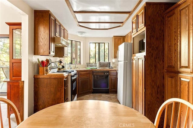 kitchen featuring sink, gas range, dishwasher, and white refrigerator