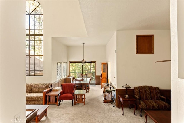 carpeted living room featuring a high ceiling