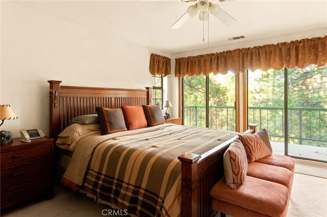 carpeted bedroom featuring access to exterior and ceiling fan