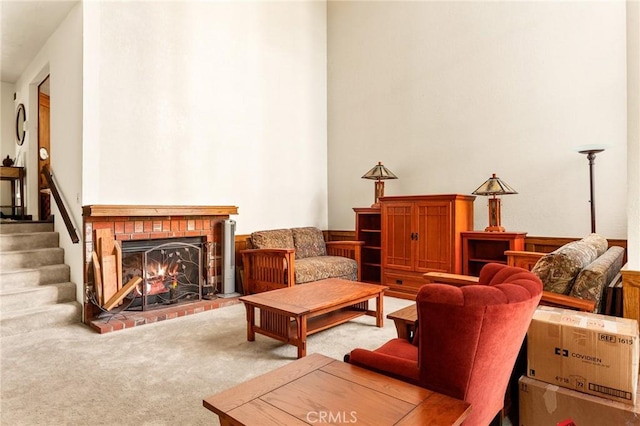 sitting room with a fireplace and carpet floors