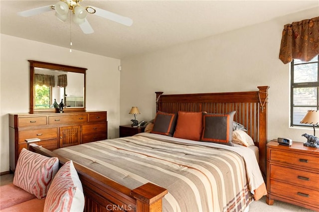 bedroom with ceiling fan and light carpet