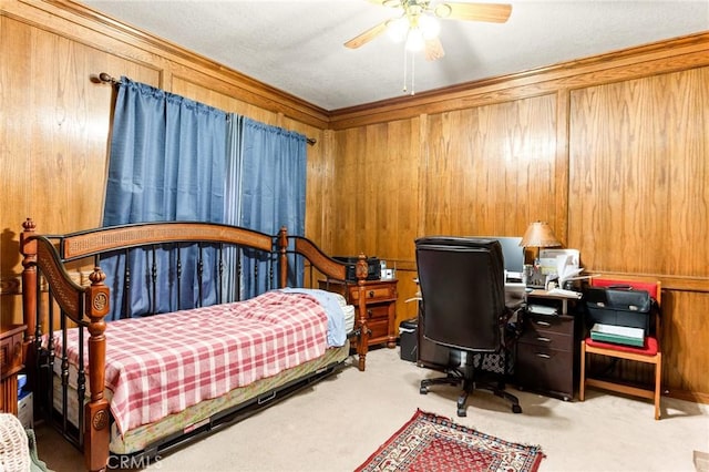 bedroom featuring carpet floors, ceiling fan, and wood walls