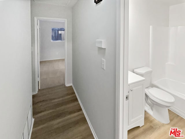 full bathroom with shower / tub combination, vanity, toilet, and wood-type flooring