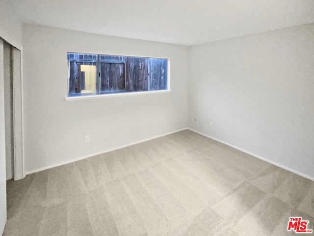 unfurnished room featuring carpet