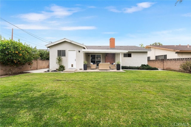 rear view of house with an outdoor living space and a lawn