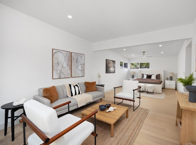 living room featuring light hardwood / wood-style floors and ceiling fan