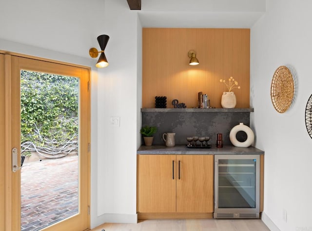 bar featuring wine cooler and backsplash