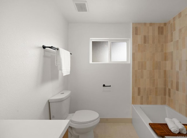 bathroom featuring vanity, tile patterned floors, and toilet