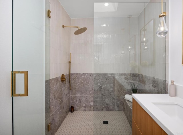 bathroom featuring an enclosed shower and vanity