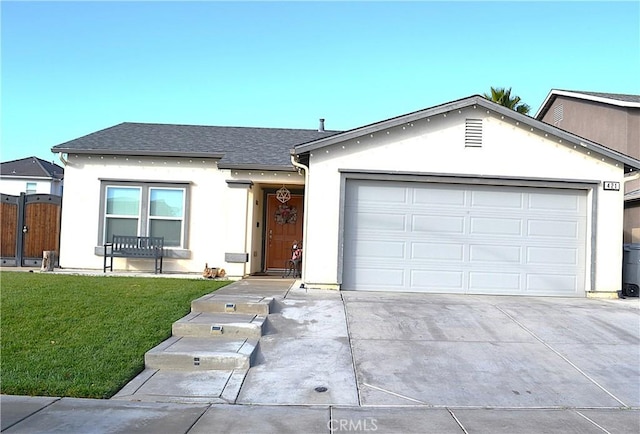 single story home featuring a garage and a front lawn