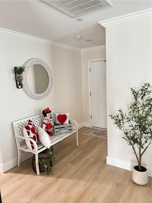 interior space featuring crown molding and wood-type flooring