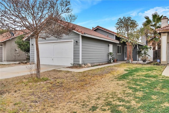 ranch-style home with a garage and a front yard