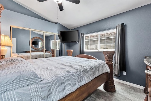 bedroom with hardwood / wood-style flooring, ceiling fan, vaulted ceiling, and a closet