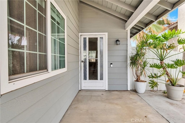 view of exterior entry featuring a patio area