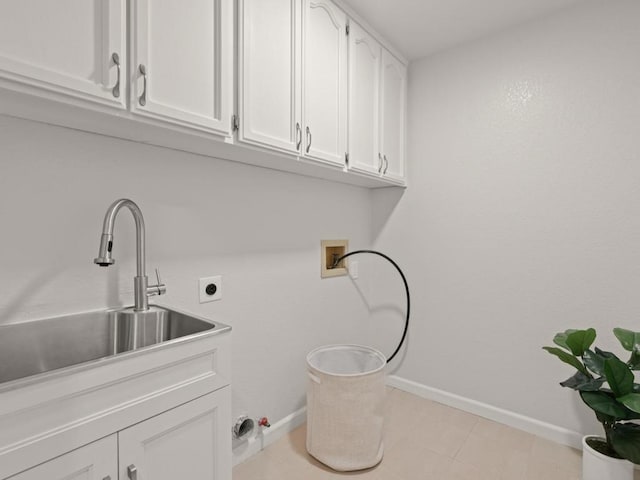 laundry area with sink, hookup for a washing machine, cabinets, and hookup for an electric dryer