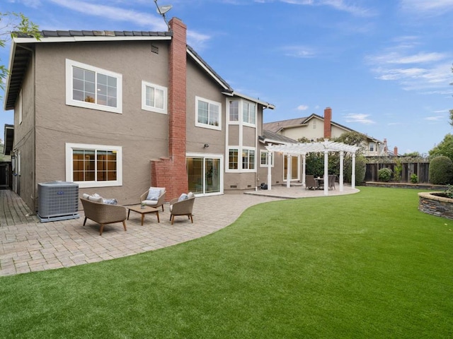 rear view of property featuring cooling unit, a yard, a pergola, and a patio area