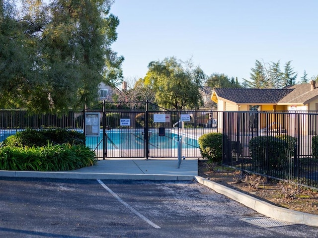 view of gate featuring a community pool