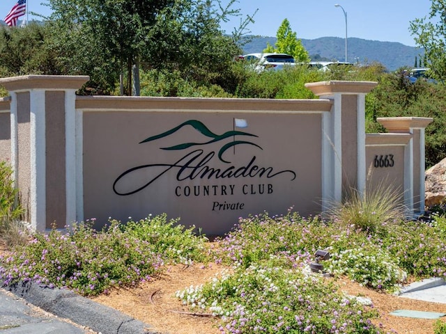 community / neighborhood sign with a mountain view