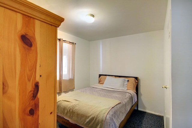 bedroom featuring dark colored carpet