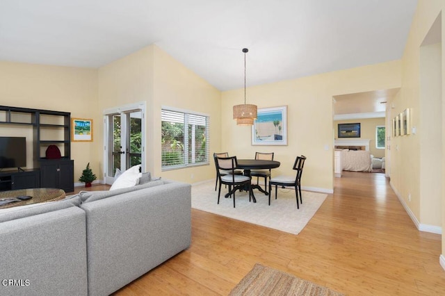 living room with lofted ceiling and light wood-type flooring