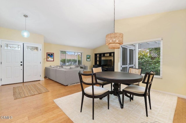 dining area with lofted ceiling and wood-type flooring