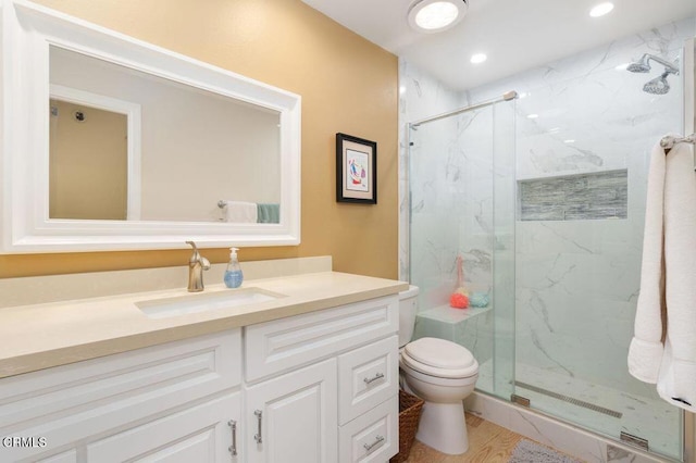 bathroom with vanity, toilet, and walk in shower