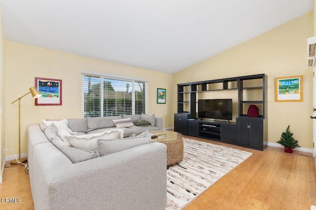 living room featuring hardwood / wood-style flooring and lofted ceiling