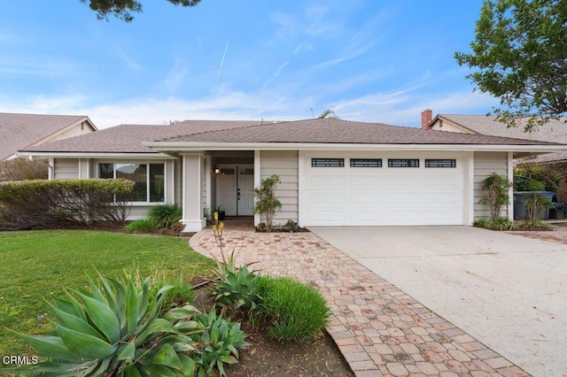 ranch-style home featuring a garage and a front yard