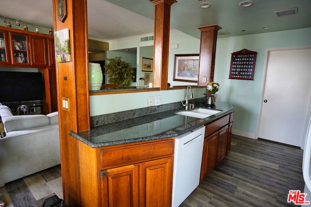 kitchen with dark hardwood / wood-style floors, decorative columns, sink, dark stone counters, and white dishwasher