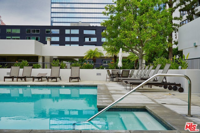 view of swimming pool with a community hot tub and a patio