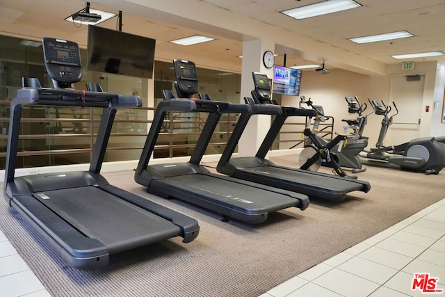 exercise room with tile patterned floors