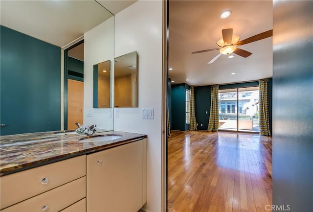 bathroom featuring vanity, hardwood / wood-style flooring, and ceiling fan