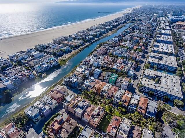 birds eye view of property with a beach view and a water view