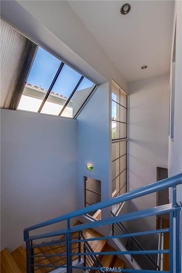 staircase with hardwood / wood-style floors