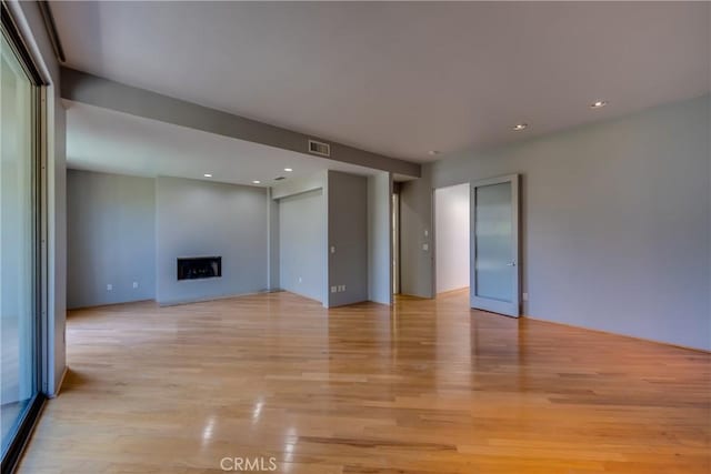 unfurnished living room featuring light hardwood / wood-style flooring