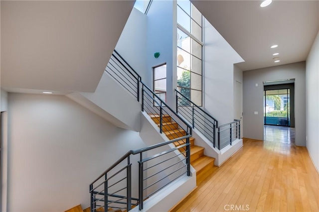 stairs with hardwood / wood-style floors