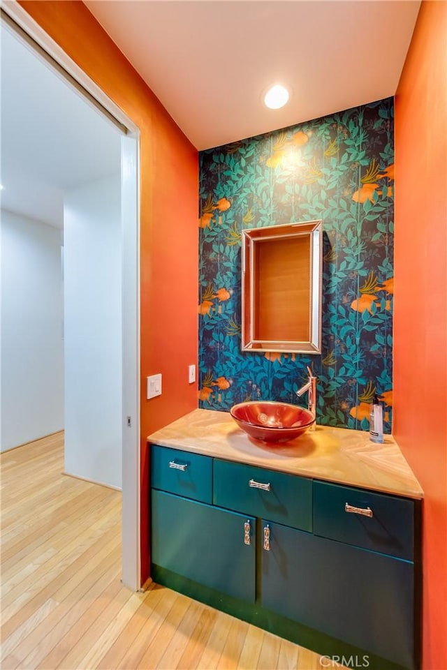 bathroom featuring hardwood / wood-style flooring and vanity