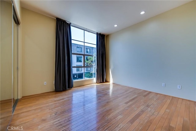 empty room with light hardwood / wood-style flooring