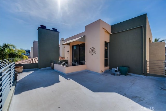 rear view of property with a balcony