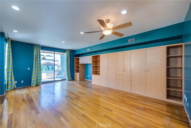 unfurnished living room featuring ceiling fan and light hardwood / wood-style flooring